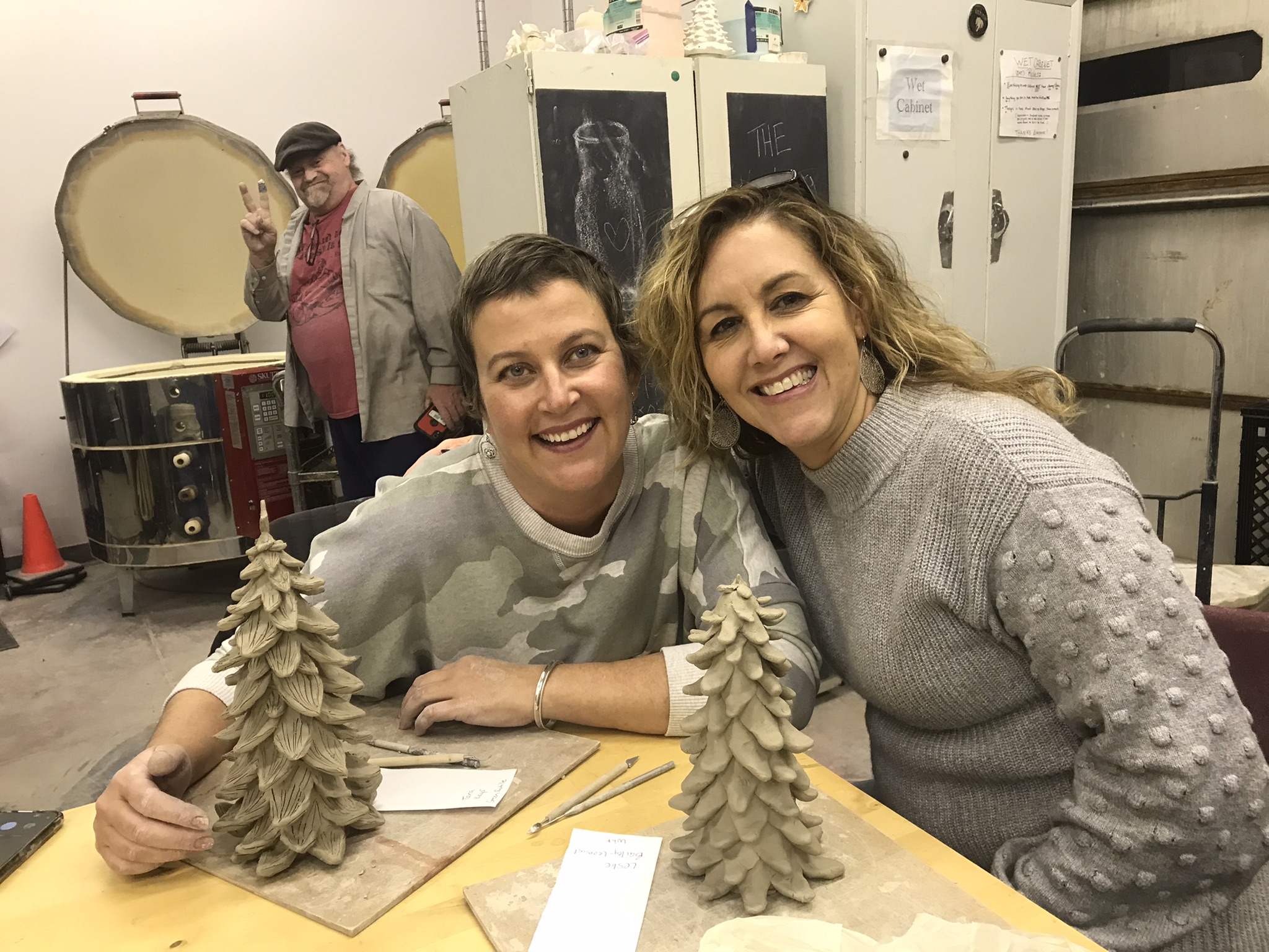 two pottery students making ceramic christmas trees