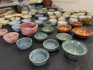 hundred of ceramic bowls on display made as a fundraiser for Empty Bowls 