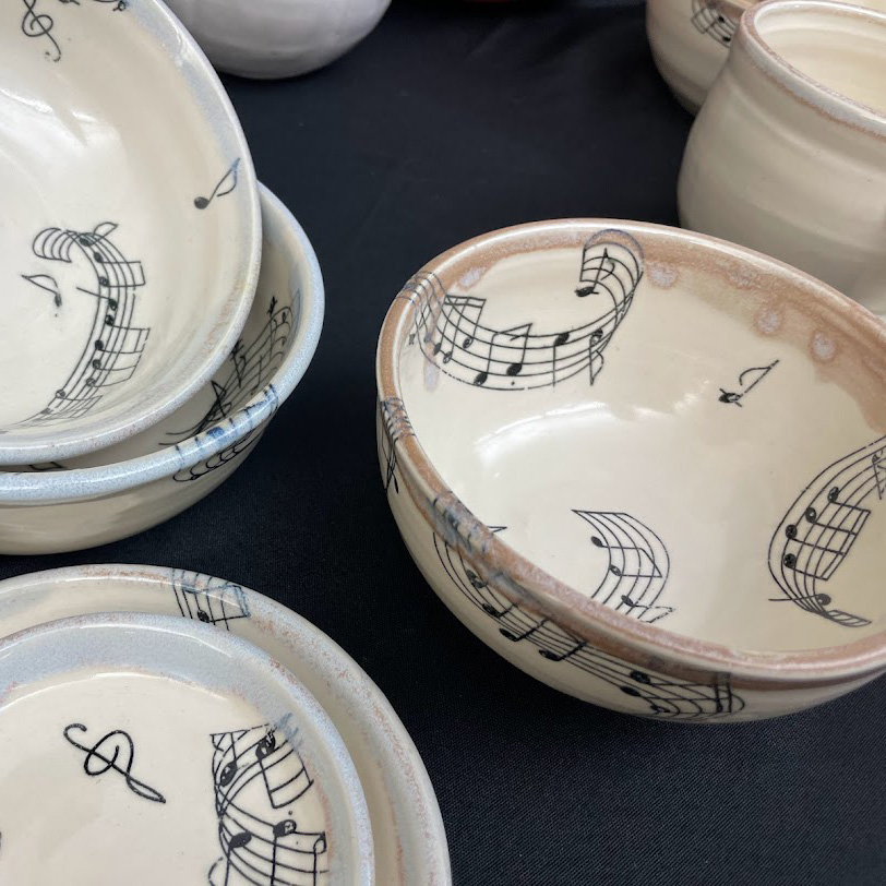 set of white ceramic bowls with music notes