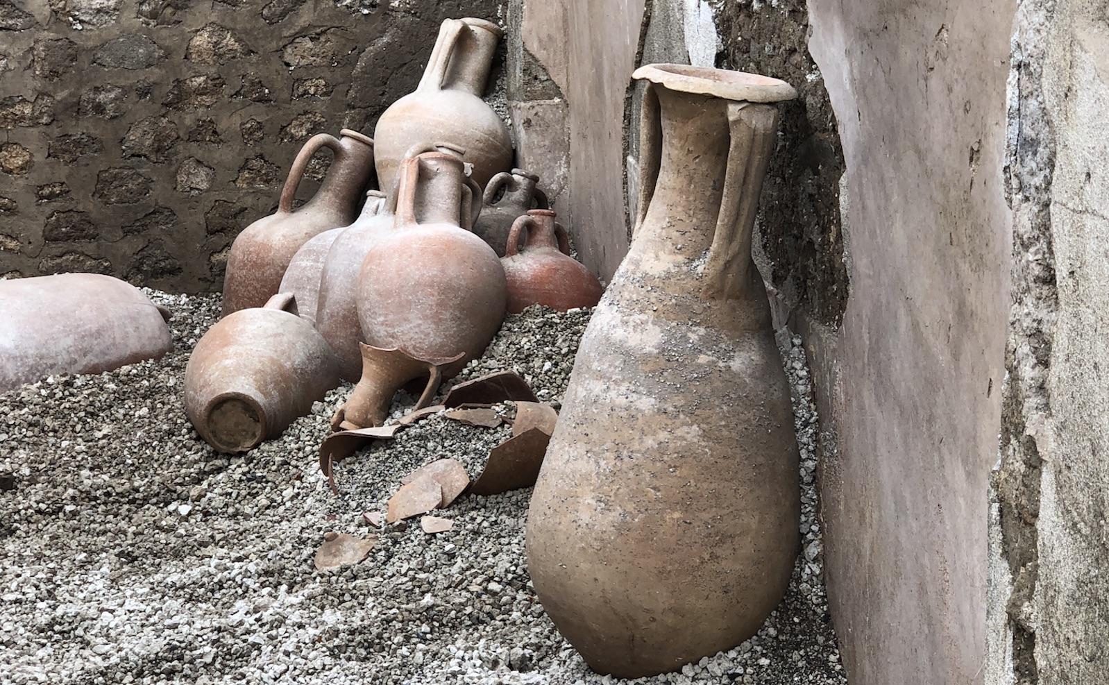 several clay vases and jugs from the ruins of pompeii