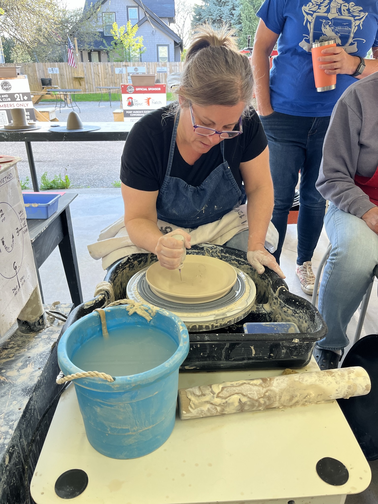 pottery instructor working on wheel at foundry
