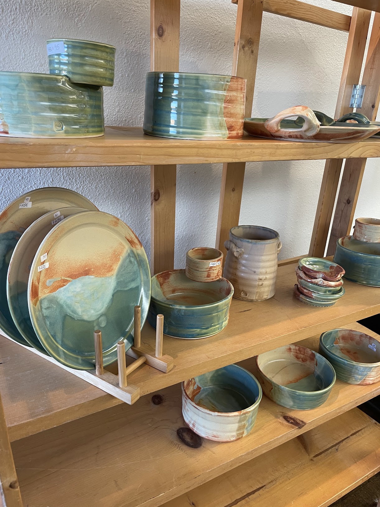 teal and sand colored handmade pottery at Foundry's 2023 pottery market