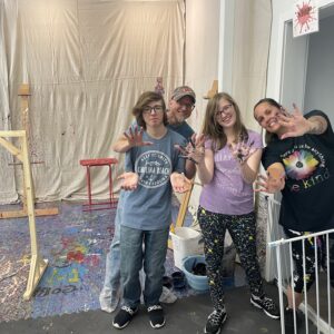 a family of four posing after splatter paint session