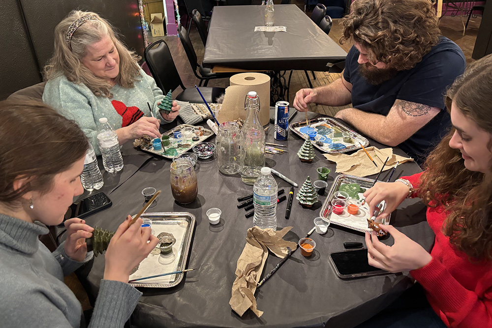 a group of friends working hard on their art bar projects