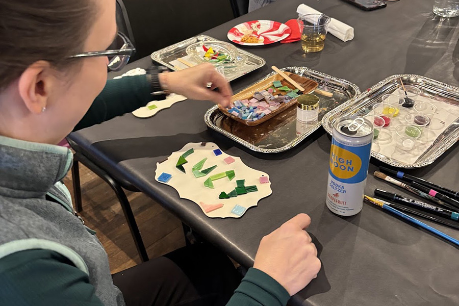 art bar customer works on a mosaic with a high noon